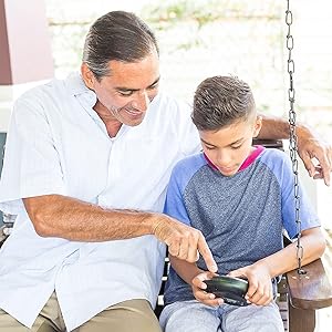 Man helping boy play with Brainbolt the electronic memory game
