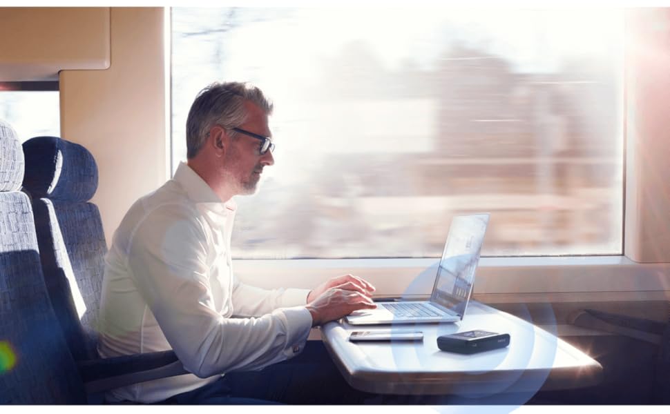 Man using DWR-2101 5G Wi-Fi 6 Mobile Hotspot on a train.