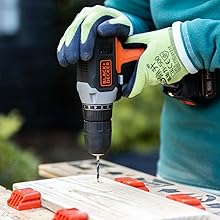 drilling into a piece of wood with a black+decker drill