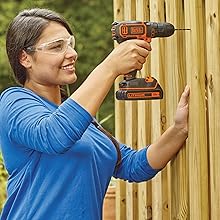 woman drilling into wood with black+decker drill