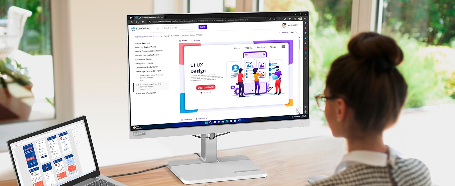 Mujer trabajando frente a monitor Lenovo L24m-40